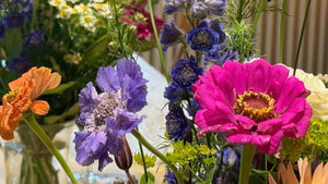 Colourful bouquet of flowers including purple, blue, and pink flowers with green leaves and similar to flowers available for national Uk delivery