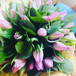 A beautiful hand tied bouquet of lilac tulips with eucalyptus foliage. Presented in an aqua-pack and gift bag. 