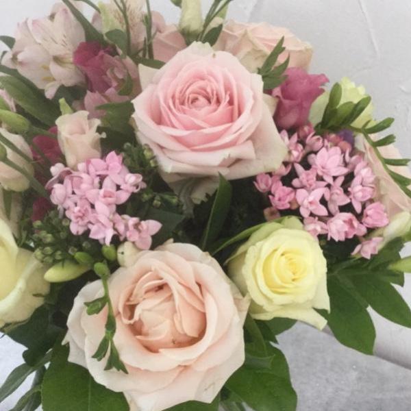A selection of pink, pale pink and cream flowers including Sweet Avalanche Roses, Cream Avalanche Roses, Pink Bouvardia, Freesias, Pink Eustoma and foliage. Hand tied, aqua packed and presented in a gift bag.